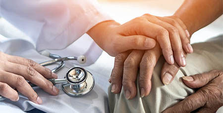 A doctor comforts a patient.